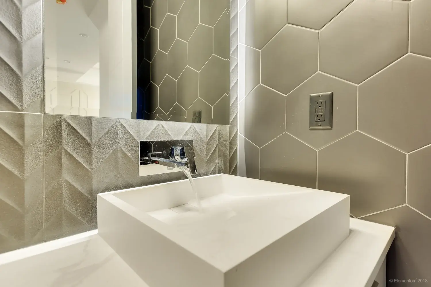 Powder room vessel sink with wall mount faucet and hexagon tile wall in Vancouver