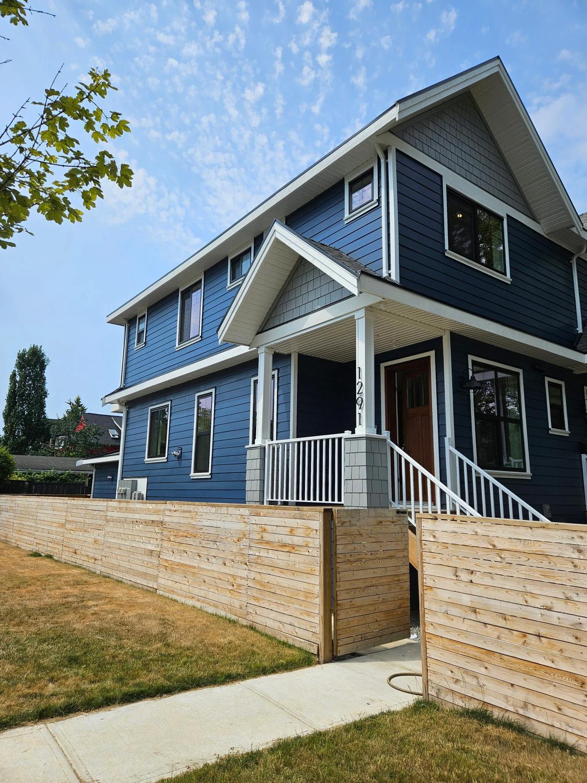 Vancouver blue heritage style home front entrance with wood door and covered porch