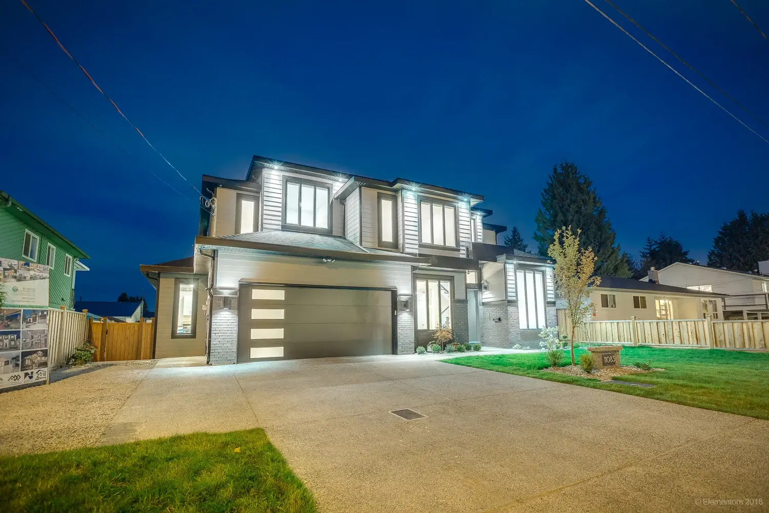 Vancouver two story home exterior with attached garage and driveway at dusk
