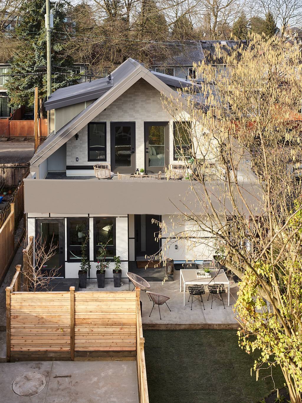 Vancouver home exterior with brick siding, metal roof, and private backyard patio